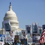 Demonstrators hold up signs during “Stop Watching Us: A Rally Against Mass Surveillance” march near U.S. Capitol in Washington